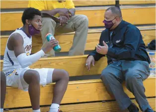  ?? COURANT FILE ?? Prince Tech boys basketball head coach Kendall May, right, speaks with Dajon Nelson in 2021.