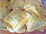  ?? AMY DEWALL DADMUN ?? Puff pastry is stuffed with avocado, cream cheese and salsa in this appetizer.