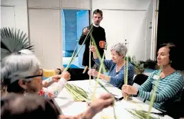 ?? PHOTOS BY MEGHAN MCCARTHY USA TODAY NETWORK ?? The Rev. Tim Schenck, of Bethesda-by-the-Sea in Palm Beach, watches volunteers and flower guild members make hundreds of palm crosses in preparatio­n for Palm Sunday.