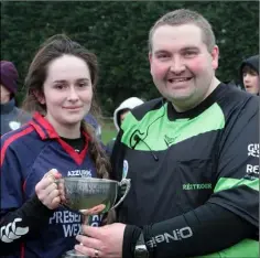  ??  ?? Aine Ennis of Presentati­on (Wexford) receives the cup from match referee Martin Quilty.