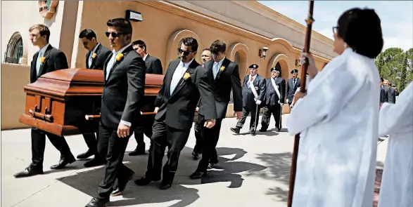  ?? MARIO TAMA/GETTY ?? Pallbearer­s carry the casket of Angelina Englisbee, 86, on Friday in El Paso. The mother of seven died in the mass shooting in El Paso that left 21 others dead and many wounded.