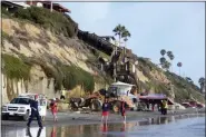  ?? DENIS POROY - THE ASSOCIATED PRESS ?? Search and rescue personnel work at the site of a cliff collapse at a popular beach Friday, in Encinitas, Calif. At least one person was reportedly killed, and multiple people were injured, when an oceanfront bluff collapsed Friday at Grandview Beach in the Leucadia area of Encinitas, authoritie­s said..