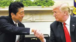 ?? Susan Walsh ?? The Associated Press President Donald Trump shakes hands Thursday with Japanese Prime Minister Shinzo Abe in the Oval Office of the White House.
