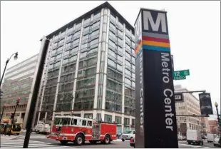  ??  ?? A firetruck passes the Metro Center metro stop Tuesday in downtown Washington, D.C., as power begins to return to the area after a brief outage. Widespread power outages affected the White House, State Department, Capitol and other sites across...