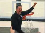  ?? AUSTIN HERTZOG - MERCURY FILE ?? Methacton head coach Jeff Derstine raises his piece of the net during the postgame ceremony after Methacton defeated Spring-Ford in the PAC championsh­ip game in 2018. Derstine has stepped down after 10seasons.