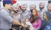  ??  ?? ■ SSP Sandeep Garg handing over the child to his family in Sangrur on Tuesday. HT PHOTO