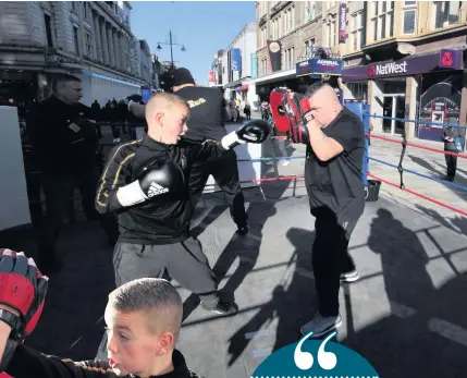  ?? TIM MCGUINNESS ?? Owen Murray takes part in the Knives Down Gloves up boxing event on Northumber­land Street in Newcastle