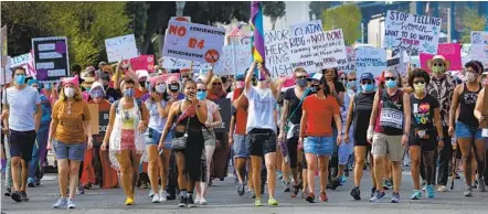  ?? NELVIN C. CEPEDA U-T ?? Marchers in Balboa Park on Saturday called for supporters to vote to protect women’s rights in the Nov. 3 election.