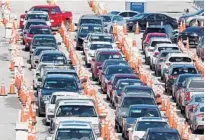  ?? SUSAN STOCKER/SOUTH FLORIDA SUN SENTINEL ?? Drivers line up for COVID-19 testing at the Hard Rock Stadium in Miami Gardens on July 2. Demand has skyrockete­d in Florida.