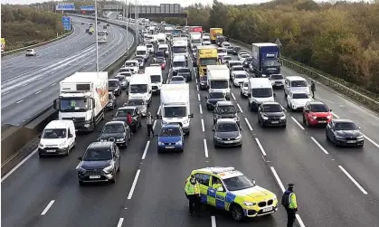  ?? Photograph: Just Stop Oil/PA ?? Police stopping traffic on the M25 motorway, where a Just Stop Oil protest was taking place on 8 November.