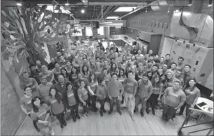  ?? COURTESY OF WATTPAD ?? Wattpad employees gather for a photo in the company’s office in Toronto.