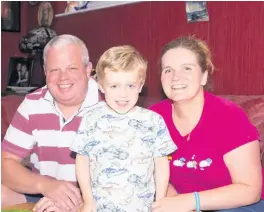  ??  ?? Giggler Happy Somhairle with dad Gerry and mum Sarah