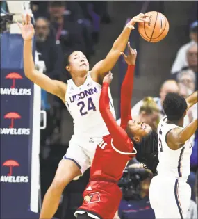  ?? Stephen Dunn / Associated Press ?? UConn’s Napheesa Collier (24) blocks a shot by Louisville’s Dana Evans Monday in Storrs.