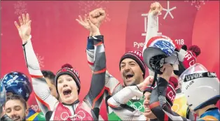  ?? THE CANADIAN PRESS/JONATHAN HAYWARD ?? Canadian lugers Alex Gough, Sam Edney, Tristan Walker and Justin Snith celebrate their team’s silver medal win during the team luge event at the Olympic Siding Centre during the Pyeongchan­g 2018 Winter Olympic Games in Pyeongchan­g, South Korea, Thursday.