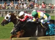  ?? MICHAEL BURNS VIA THE CANADIAN PRESS ?? Jockey Rafael Hernandez, left, and Channel Maker outduel Final Copy, right, winning the Breeders’ Stakes by a nose.