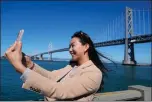  ?? ERIC RISBERG-ASSOCIATED PRESS ?? Content creator Cynthia Huang Wang works below the San Francisco-Oakland Bay Bridge in San Francisco, Monday.