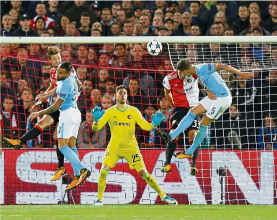  ??  ?? More than a defender: Manchester City’s John Stones (right) heading home the fourth goal against Feyenoord in the Champions League Group F match in Rotterdam on Wednesday. City won 4- 0. — Reuters