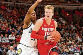  ?? DYLAN BUELL/ GETTY IMAGES ?? Justin Ahrens (right) of Ohio State dribbles the ball while being guarded by Cassius Winston (left) of the Michigan State during the 2019 Big Ten Basketball Tournament. Ohio State is ranked no. 18 in the preseason AP poll.