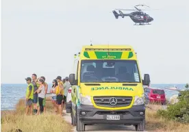  ?? Picture / NZME ?? Several members of the public helped emergency services search for the woman while others watched from the beach.