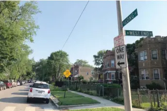  ?? ANDY GRIMM/SUN-TIMES ?? A street sign marks the 100 block of North Long Avenue, where Chicago Police Cmdr. Patrina Wines and a police sergeant were shot as police dispersed a crowd gathered for a Fourth of July block party. Wines was struck in the foot as she talked with residents on the street.