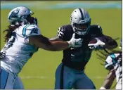  ?? BRIAN BLANCO — THE ASSOCIATED PRESS FILE ?? Las Vegas Raiders running back Josh Jacobs, right, runs past Carolina Panthers defensive tackle Bravvion Roy during the second half Sunday, Sept. 13, in Charlotte, N.C.