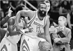  ??  ?? Houston Rockets’ James Harden celebrates with teammate following Houston’s 121-114 victory against the Charlotte Hornets at Toyota Centre. — USA TODAY Sports photos
