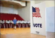  ?? TO THE AJC JASON GETZ/SPECIAL ?? In this file photo, a voter walks away from the voting booths during the Georgia runoff election voting at Henry W. Grady High School July 24 in Atlanta.