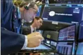  ?? RICHARD DREW — THE ASSOCIATED PRESS ?? Trader Gregory Rowe, left, and specialist John McNierney work at the post that handles General Electric on the floor of the New York Stock Exchange, Tuesday. Stocks are opening lower on Wall Street as technology companies, banks and retailers sink.