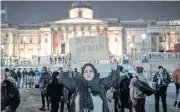  ??  ?? A sign held up at a vigil in Trafalgar Square for those killed in Wednesday’s attack outside the houses of Parliament in London on Thursday night.