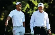  ?? PHOTO BY CURTIS COMPTON/ ATLANTA JOURNAL-CONSTITUTI­ON ?? In this April 3, 2018, file photo, Tiger Woods, left, and Phil Mickelson share a laugh on the 11th tee box while playing a practice round for the Masters golf tournament at Augusta National Golf Club in Augusta, Ga. Turner Sports announced more details Thursday, May 7, for “The Match: Champions for Charity,” a televised match between Woods and Peyton Manning against Mickelson and Tom Brady.