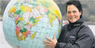  ??  ?? Ellen MacArthur, holds up a globe after sailing solo around the world in record time.The 28-year-old, later made a Dame, sailed her boat B&amp;Q into Falmouth in Cornwall, completing her voyage in 71 days 14 hours 18 minutes and 33 seconds – beating the world record by 33 hours