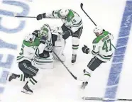  ?? THE CANADIAN PRESS VIA AP] ?? Dallas Stars goalie Anton Khudobin (35), Mattias Janmark (13), Alexander Radulov (47) and Jason Dickinson (18) celebrate their win over the Vegas Golden Knights during overtime NHL Western Conference final playoff game action in Edmonton, Alberta, on Monday. [JASON FRANSON/