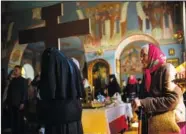  ?? (File Photo/AP/Francisco Seco) ?? A Christian Orthodox worshipper attends a service May 15 at Archangel Saint Michael monastery in Odesa.
