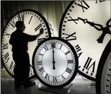  ?? ELISE AMENDOLA — ASSOCIATED PRESS FILE ?? Electric Time Co. employee Walter Rodriguez cleans the face of an 84-inch Wegman clock at the plant in Medfield, Mass., in 2008. Most Americans will set their clocks forward by one hour this weekend.