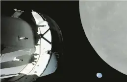  ?? NASA ?? A screengrab from NASA TV shows the capsule nearing the moon. Also in view, “our pale blue dot and its 8 billion human inhabitant­s,” said Mission Control’s commentato­r.