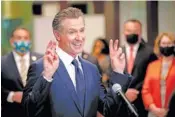  ?? WATCHARA PHOMICINDA/THE ORANGE COUNTY REGISTER VIA AP ?? California Gov. Gavin Newsom makes a gesture as he speaks Friday during a news conference at San Bernardino Unified School District Office after visiting Juanita B. Jones Elementary School in San Bernardino, Calif.