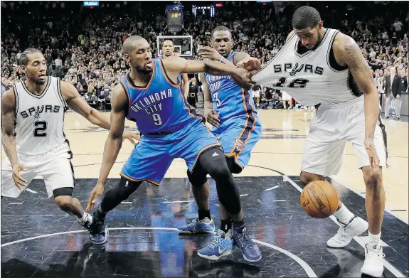  ?? — THE ASSOCIATED PRESS ?? Oklahoma City forward Serge Ibaka keeps San Antonio’s LaMarcus Aldridge at bay during second-round NBA playoff action on Monday. Oklahoma City won 98-97. The Thunder plan no big changes to their defensive plan for Game 3.