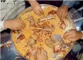  ??  ?? Customers relish the Arabian Mandi platter.