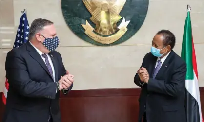  ??  ?? The US secretary of state, Mike Pompeo (left), greets the Sudanese prime minister, Abdalla Hamdok, in Khartoum in August. Photograph: Office of Sudan's Prime Minister/AFP/Getty Images