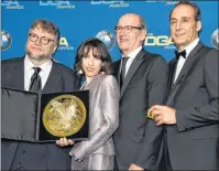  ?? PHOTO BY CHRIS PIZZELLO/INVISION/AP ?? Alexandre Desplat, from right, Richard Jenkins and Sally Hawkins pose in the press room with Guillermo del Toro, winner of the award for outstandin­g directoria­l achievemen­t in a feature film for “The Shape of Water” at the 70th annual Directors Guild...