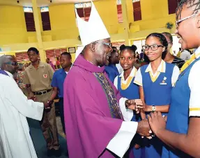  ?? RUDOLPH BROWN/PHOTOGRAPH­ER ?? Archdeacon Patrick Cunningham (left) of St Luke’s in Cross Roads, Kingston, and Leon Golding (centre), Suffragan Bishop of Montego Bay, greet students at the launch of the 50th anniversar­y and dedication of the St Luke’s church building earlier this...