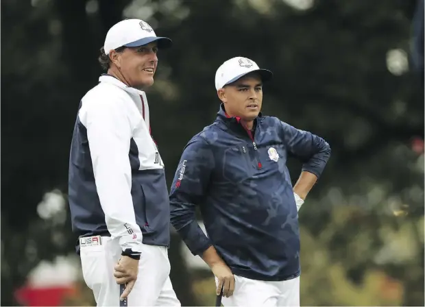  ?? SAM GREENWOOD / GETTY IMAGES ?? Phil Mickelson, left, and Rickie Fowler of the United States look on during a practice prior to the 2016 Ryder Cup on Wednesday in Chaska, Minn.
