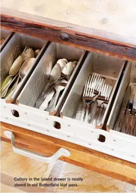  ??  ?? Cutlery in the island drawer is neatly stored in old Butterfiel­d loaf pans.