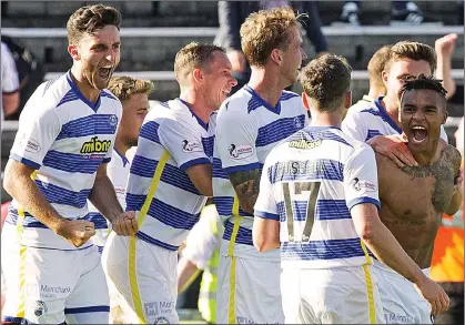  ??  ?? ROARING BACK: an elated Quitongo (far right) is mobbed by his Morton team-mates after netting a stoppage-time winner