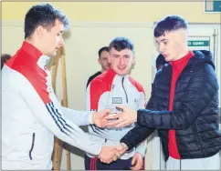  ?? ?? Kyle Wallace receiving winning medals from Eoin Davis and Niall O’Leary at the recent St Catherines Juvenile GAA medal presentati­ons.