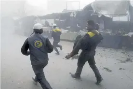  ?? Picture / AP ?? Members of the the White Helmets civil defence group clear victims of the attacks on Eastern Ghouta.