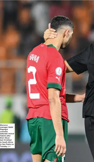  ?? AFP ?? Morocco manager Walid Regragui consoles defender Achraf Hakimi after their Afcon last-16 defeat to South Africa in San Pedro on Tuesday