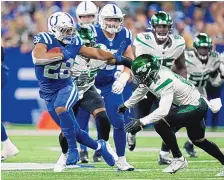  ?? AJ MAST/ASSOCIATED PRESS ?? Indianapol­is running back Jonathan Taylor pulls away from New York Jets defender Ashtyn Davis during Monday night’s game. Taylor rushed for 172 yards as the Colts beat the Jets, 45-30.