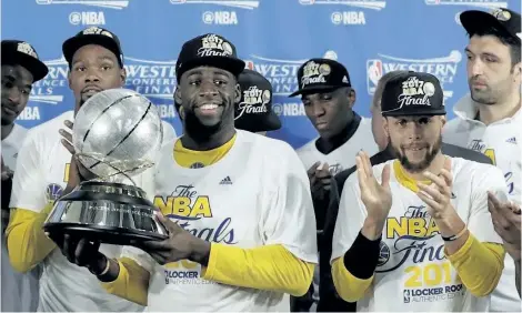  ?? ERIC GAY/THE ASSOCIATED PRESS ?? Golden State Warriors’ Draymond Green carries the NBA Western Conference trophy as Kevin Durant, left rear, and Stephen Curry, front right, cheer after their 129-115 win over the San Antonio Spurs in Game 4 of the Western Conference finals, Monday in...