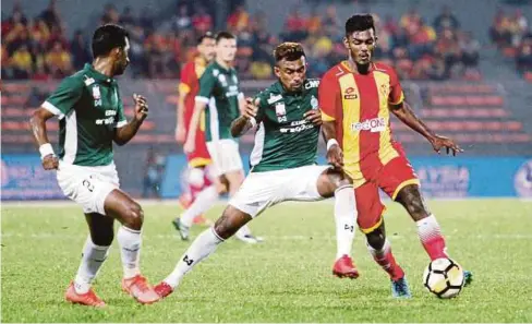  ??  ?? PEMAIN Selangor, Kannan Kalaiselva­n (kanan) disekat pemain Melaka United, Surendran Ravindran (tengah) pada Ahad lalu.